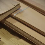 Edge of sliced beech veneer pack showing sheet thickness of 0.6 mm.