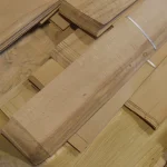 Pack of natural sliced beech veneer on a wooden base.