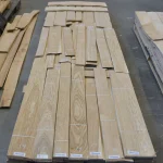 Top view of laid out packs of sliced oak veneer 0.6 mm in the warehouse.