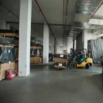 Forklift moving a pallet of sliced veneer in the WoodWay Expert warehouse.