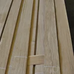 Sheets of natural sliced oak veneer tied into bundles.