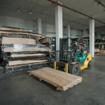 Forklift moving a pallet of sliced oak veneer at the WoodWay Expert warehouse.