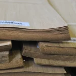 Edges of sliced oak veneer pack showing sheet thickness of 0.6 mm