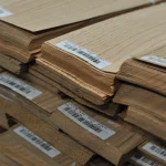 Edges of natural sliced red oak veneer sheets 0.6 mm thick with barcode labels.