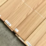 Packs of natural sliced red oak veneer 2.1 to 3.8 m long in a warehouse.