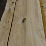 Detailed grain pattern and knots on the surface of sliced oak veneer