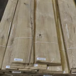 Stacked sliced oak veneer packs with knots 2.1-3.8 m long with barcodes