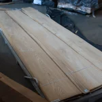 Bundle of sliced oak veneer with knots 2.1-3.8 m long in the warehouse