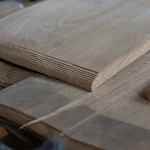 Edge of the sliced oak veneer pack showing 0.9 mm sheet thickness