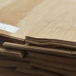 Edges of natural sliced oak veneer sheets showing 1.5 mm thickness in a stack