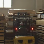 Forklift moving pallets with veneer and lumber at WoodWay Expert warehouse