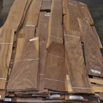 Laid out sheets of sliced American walnut veneer, 1-2 m long.