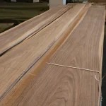 Stacked sheets of natural sliced American Walnut veneer, 3-4 meters long.