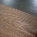 Macro photo of the unique wood grain pattern of sliced American Walnut veneer.