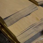 Edges of sliced European Walnut veneer sheets, 0.6 mm thick, in a pack