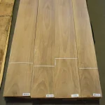 Four sheets of natural sliced European Walnut veneer laid out for inspection