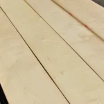 Texture of natural sliced maple veneer in a light cream shade.