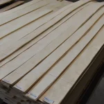 Pallets with sliced maple veneer sheets from 2.1 to 3.8 meters long in the warehouse.