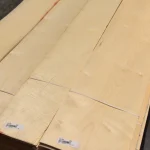 Packs of natural sliced maple veneer with labels in the warehouse.