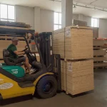 A forklift moving pallets of sliced maple veneer in the WoodWay Expert warehouse.