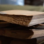 Close-up of the ends of 0.7 mm sliced pine veneer sheets in a pack.