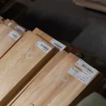 Marking and barcodes on packs of sliced pine veneer at the WoodWay Expert warehouse.
