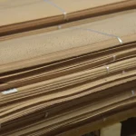 Edge of sliced beech veneer bundle showing sheet thickness of 0.6 mm