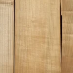 Close-up texture of natural sliced cherry veneer grade 1 showing fine wood grain.