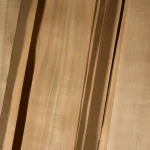 Surface of natural sliced cherry veneer grade 1 with straight wood fibers.