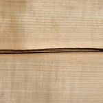 Texture of natural sliced cherry veneer with distinct annual growth rings.