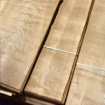 Bundles of natural sliced European cherry veneer secured with packing straps.