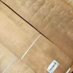 Bundles of sliced cherry veneer with barcode labels in the warehouse.