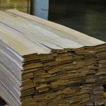 Large pallet with packs of natural sliced oak veneer in the warehouse