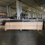 Forklift holding a pallet with natural sliced oak veneer in the warehouse