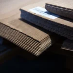 Side view of oak veneer stack showing the 1.5 mm sheet thickness and clean cut.