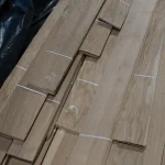 Sheets of 3rd grade sliced oak veneer tied with white straps