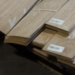 Cut edges of sliced oak veneer bundles with barcode stickers