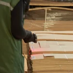 Warehouse worker scanning a barcode on a sliced oak veneer pallet