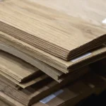 Stack of natural sliced oak veneer bundles 2.5 mm thick at WoodWay Expert warehouse.