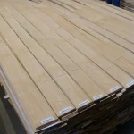 Pallet with packs of natural sliced oak veneer with barcode labels.