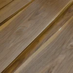 Texture and natural grain pattern of sliced American walnut veneer.