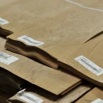 Edges of sliced European Walnut veneer packs showing 0.6 mm thickness.