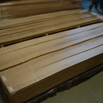 Warehouse stock of sliced European walnut veneer on pallets.