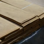 Edge of a sliced European walnut veneer pack showing 0.6 mm thickness.