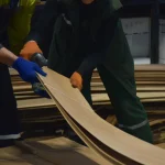 Process of selecting and measuring sliced walnut veneer sheets in the warehouse.
