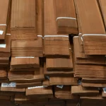 Butt ends of sliced makore veneer bundles showing 0.6 mm sheet thickness.