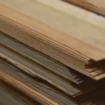 Edges of a sliced pine veneer pack showing sheet thickness