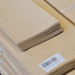 Edge of sliced alder veneer pack showing sheet thickness of 0.6 mm