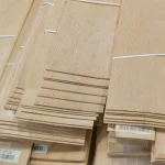 Ends of sliced alder veneer sheets showing the 2.5 mm thickness.