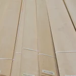 Sheets of natural sliced alder veneer bound with white straps.